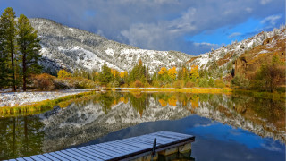 Snowy mountain lake boat dock - a boat dock free wallpaper
