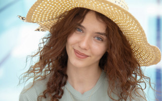 Woman smiling strawhat blue background - a straw hat free wallpaper