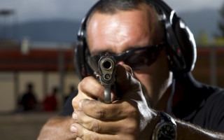 Man aiming gun headphone stock - headshot free wallpaper