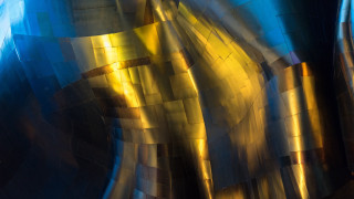 Metal object blue gold foiling - a close up of a metal object free wallpaper