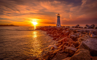 Lighthouse rocky shore sunset clouds 6 - a rocky shore free wallpaper for desktop