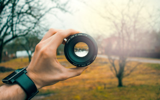 Person holding camera lens blurry 5 - objective abstraction free wallpaper