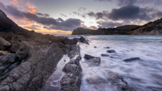 Rocky shore sunset waves mountains - wide angle len free wallpaper