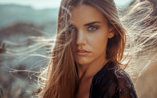 Woman longhair field wind looking - a field of grass free wallpaper