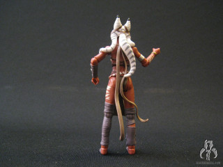 Toy figure black surface black - back view free wallpaper