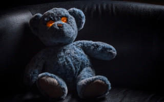 Blue teddy bear glowing eyeball - free dark wallpaper