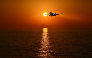 Plane ocean sunset sky sun - over the ocean free wallpaper