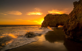 Sunset beach waves rock formation 2 - a sun setting free wallpaper