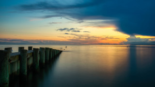 Pier lake sunset clouds bird - a long wooden pier free wallpaper