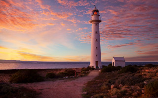 Lighthouse rocky shore sunset clouds 14 - a rocky shore free wallpaper