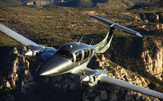 Small airplane mountain range valley - over a mountain range in the sky free wallpaper