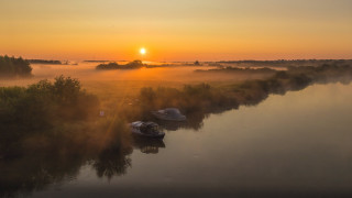 Foggy river boats sunset mountain - dave allsop free wallpaper