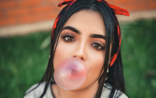 Woman blowing bubble red bow - a bubble free wallpaper