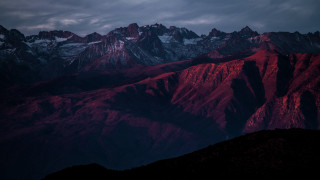 Mountain range red light cloudy - a dark sky above free wallpaper