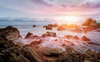 Rocky beach sunset water mountains - arthur pan free wallpaper