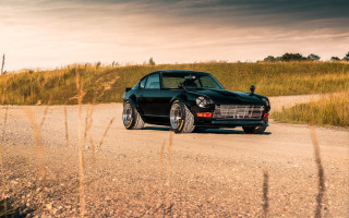 Black car dirt road field 2 - ejler bille free wallpaper