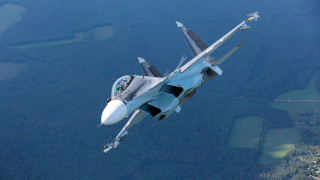 Fighter jet flying over forest 2 - a fighter free wallpaper