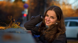 Woman smiling wall car portrait - against a wall free wallpaper
