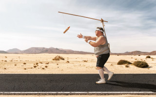 Man balancing pole beach desert - a stick free wallpaper