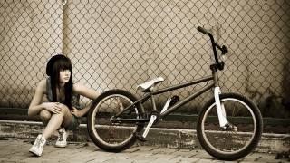Woman bike fence brick outdoors - a woman sitting next free wallpaper