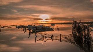 Boats lake cloudy sunset nets 2 - top of a lake under a cloudy sky free wallpaper