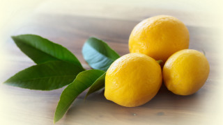 Three lemons leaves table top - a light background free wallpaper