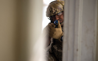 Camouflage man smiling gun action - action scene free wallpaper