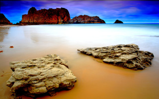 Rock formation beach blue sky - a rock formation free wallpaper