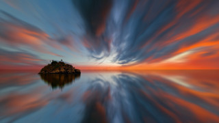 Small island cloudy sunset ocean - a sky free wallpaper