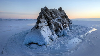 Frozen lake rock person distant - side and a person free wallpaper