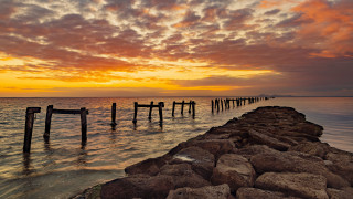 Pier beach sunset cloudy sky - a few cloud above free wallpaper