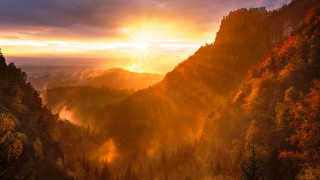 Sunset mountain trees forest sunbeam - a sunset over a mountain free wallpaper