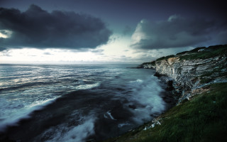 Cliff ocean cloudy sky dark - the ocean under a cloudy sky free wallpaper