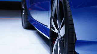 Car tire closeup white floor - a white floor free wallpaper