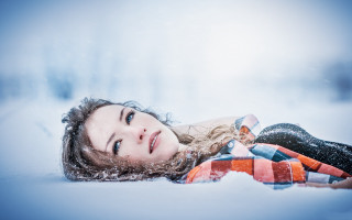 Woman snow blowing hair portrait - free winter wallpaper