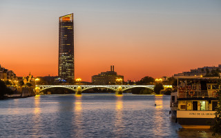 River bridge building sunset boat - a boat in the foreground free wallpaper