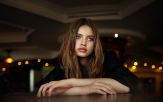 Serious blonde woman table long - the side with free wallpaper