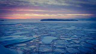 Ice water mountain sunset cityscape - a small island in the distance free wallpaper