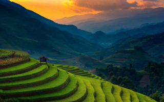 Hilltop man sunset mountain city - a green hillside free wallpaper