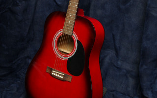 Red guitar blue black background - a red guitar free wallpaper