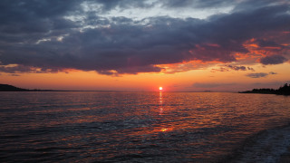 Sunset water boat clouds cityscape - free sunset wallpaper