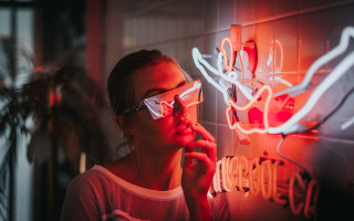 Woman glasses neon sign cyberpunk - a neon light behind her free wallpaper