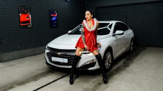 Woman red dress sitting white 3 - a brick wall behind her free wallpaper
