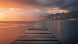 Long dock sunset mountains lighthouse - a long dock free wallpaper