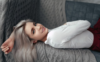 Woman smiling laying outdoors whitehair - her arm behind her head free wallpaper