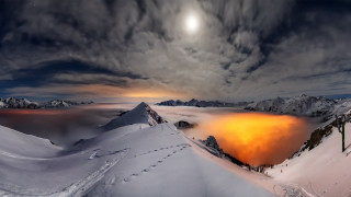 Snowy mountain orange light cloudy - snow under a cloudy sky free wallpaper