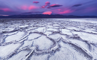 Jigsaw beach purple sky mountains - white sand free wallpaper
