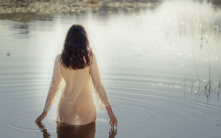 Woman lake hands in water - her back free wallpaper for desktop