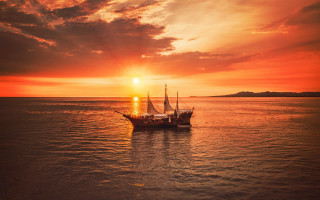 Boat sunset clouds city mountains - top of a body free wallpaper