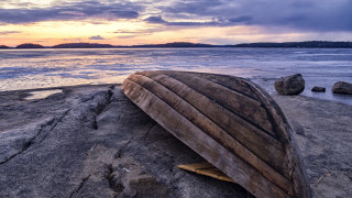 Boat rocks sunset mountains ocean - a view of the ocean and mountains free wallpaper